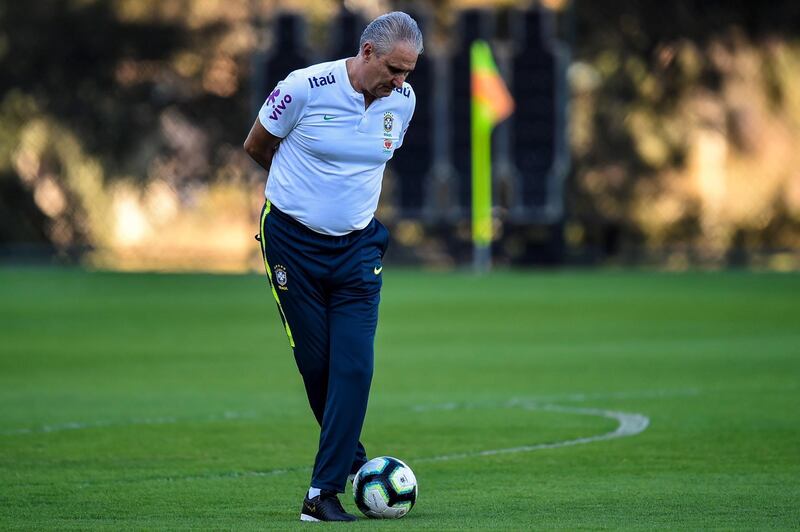 Tite, the Brazil manager, dribbles with the ball. AFP