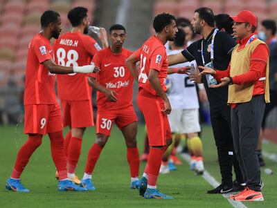 Shabab Al Ahli manager Mahdi Ali, right, speaks to team during the Asian Champions League match against Foolad. AFP