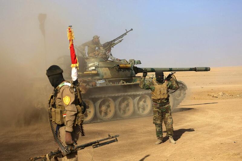 Fighters of the Popular Mobilisation Forces at the front line against Islamic State militants outside Mosul. Iraq's parliament has voted to accord full legal status to government-sanctioned Shiite militias as a back-up and reserve force for the military and police and to empower them to deter security and terror threats facing the country.  Anmar Khalil / AP Photo