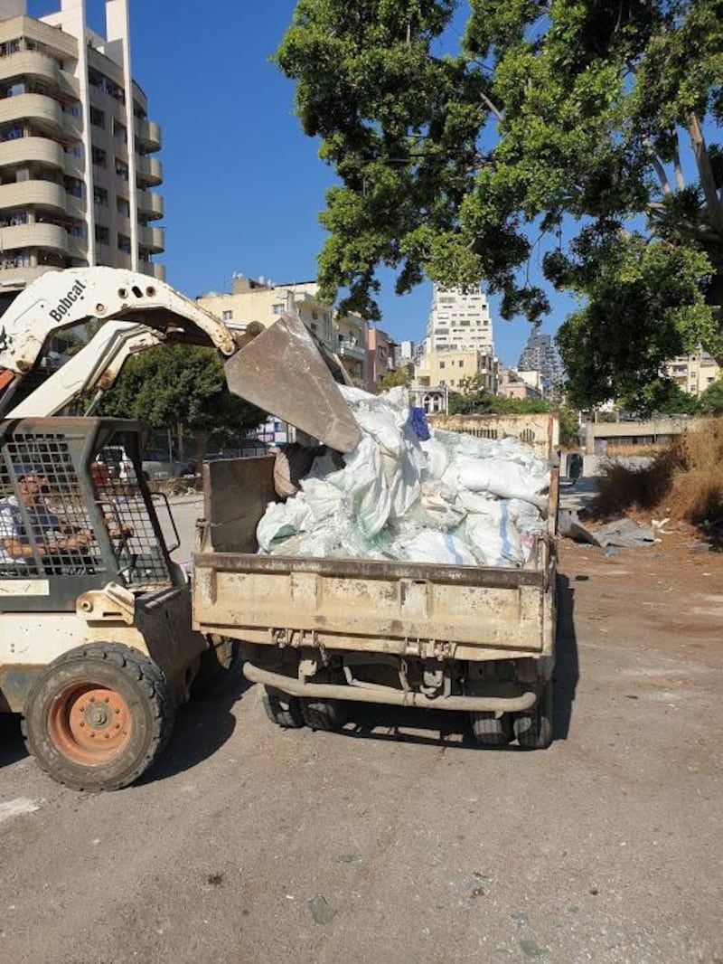 Pick up trucks going door to door to collect the shattered glass. Courtesy Ziad Abi Chaker