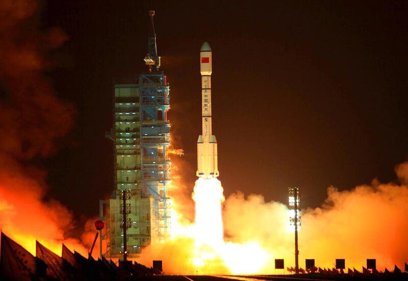 (FILES) This file picture taken on September 29, 2011 shows China's Long March 2F rocket carrying the Tiangong-1 module, or "Heavenly Palace", blasting off from the Jiuquan launch centre in Gansu province. 
A defunct Chinese space lab plunged through Earth's atmosphere on April 2, 2018, breaking apart as it headed towards a watery grave in the South Pacific, Beijing said. / AFP PHOTO / - / China OUT