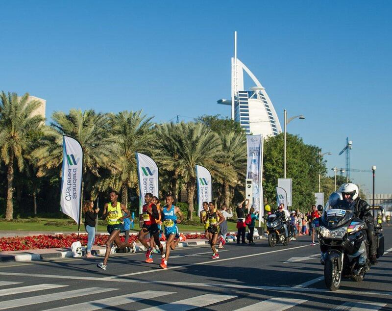 Runners are shown passing the Burj Al Arab during the 2015 Dubai Marathon on Friday. Stephen Hindley / AP