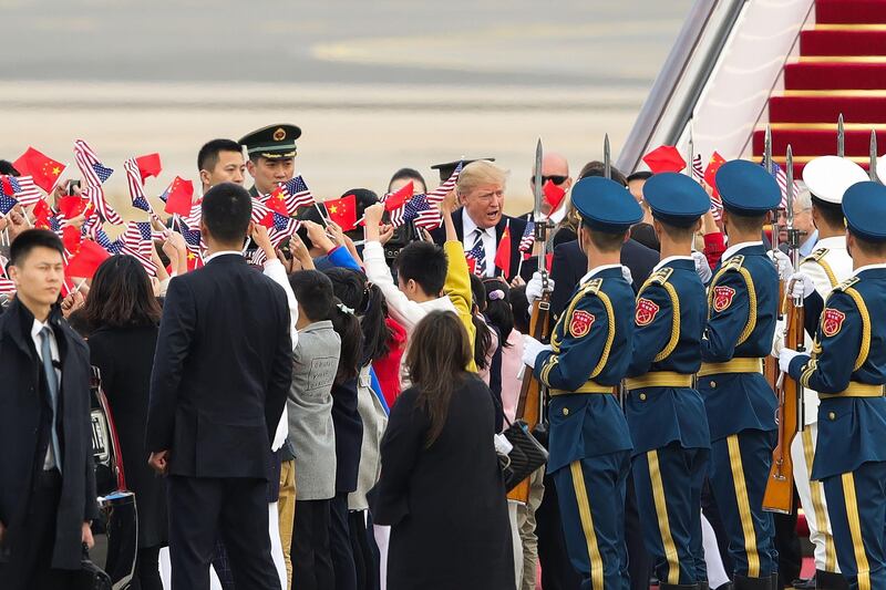 US President Donald Trump is greeted, as he and first lady Melania Trump arrive in Beijing, China. Lintao Zhang / AFP Photo