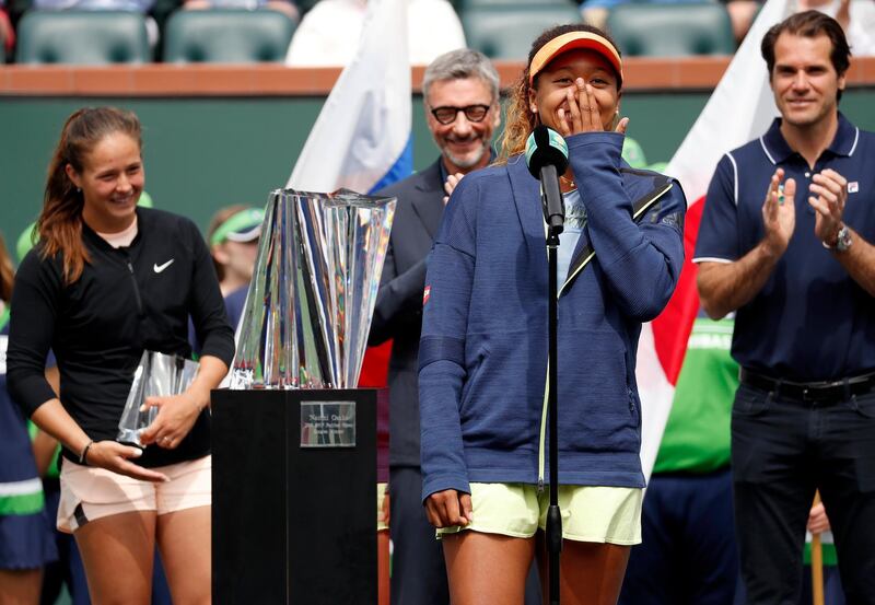 epa06613229 Naomi Osaka of Japan (C) shares a laugh during her acceptance speech as Daria Kasatkina of Russia (L) and Tournament Director Tommy Haas of Japan (R) look on during the BNP Paribas Open Finals ceremony at the Indian Wells Tennis Garden in Indian Wells, California, USA, 18 March 2018. Osaka defeated Kasatkina to win the tournament.  EPA/JOHN G. MABANGLO