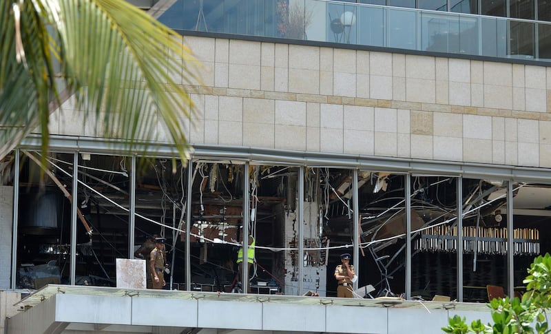 Sri Lankan police stand at the site of an explosion in a restaurant area of the Shangri-La Hotel.  AFP