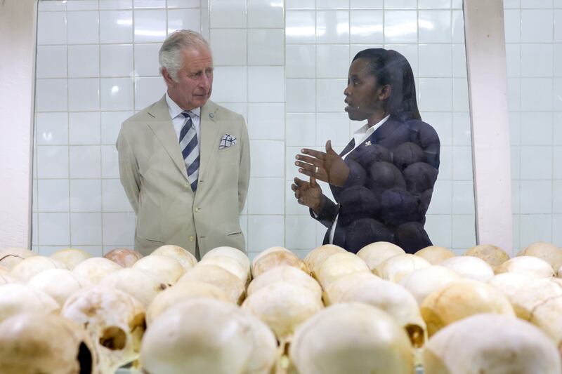 Manager Rachel Murekatete shows Prince Charles the skulls of victims at the Nyamata Church Genocide Memorial in the Rwandan capital. PA