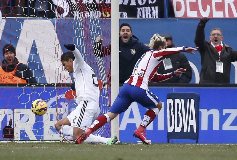 Atletico Madrid's Antoine Griezmann begins to celebrate as he scores his side's third goal in their 4-0 La Liga win over Real Madrid on Saturday. Sergio Perez / Reuters