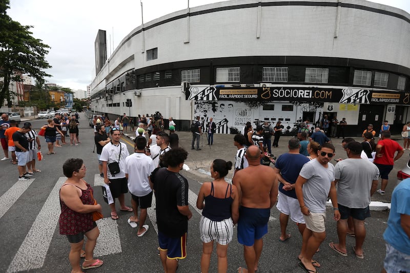 Santos fans gather in front of the Vila Belmiro stadium to pay tribute to late Brazilian football legend Pele. EPA