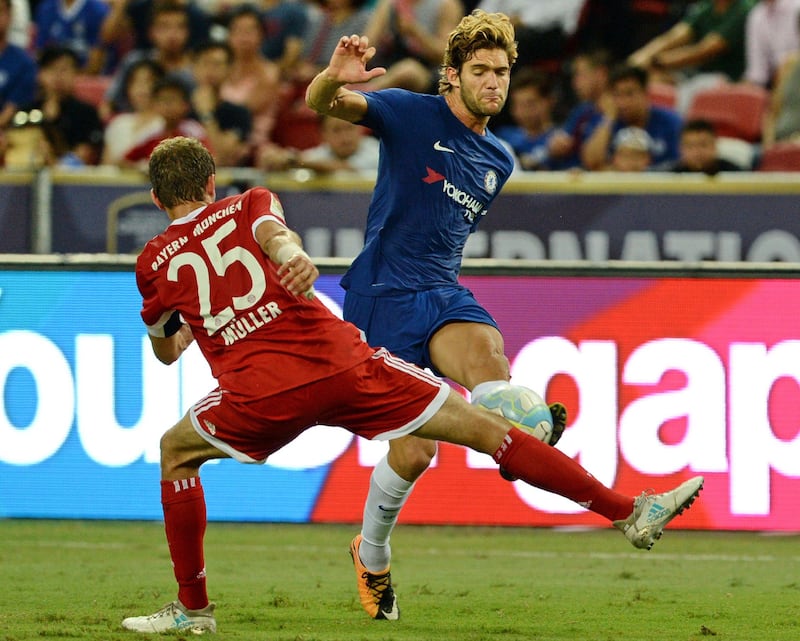 Chelsea's Marco Alonso is challenged by Bayern Munich's Thomas Muller. Roslan Rahman / AFP