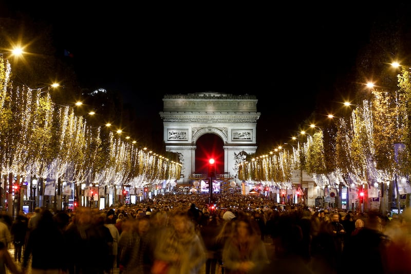 People attend the unveiling of the Christmas lights along the Champs Elysees in Paris. Reuters