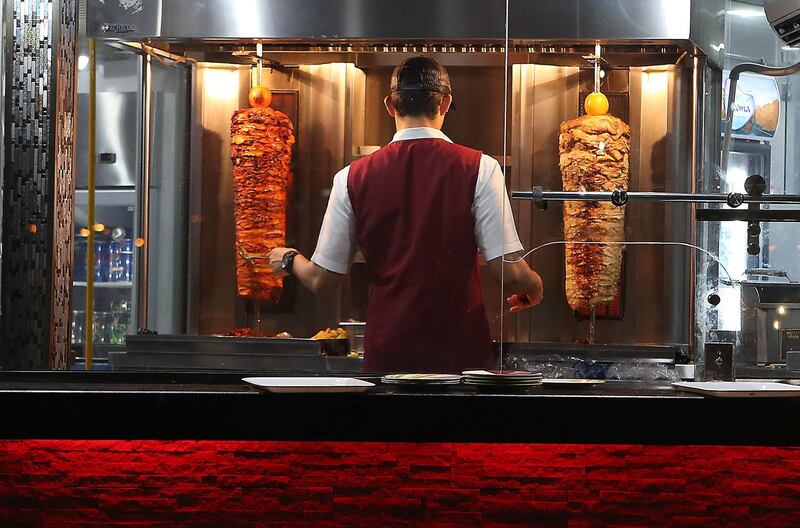 
DUBAI , UNITED ARAB EMIRATES – May 18 , 2017 : Worker preparing chicken shawarma at the Al Abra cafeteria in Deira Dubai during the evening in Dubai. ( Pawan Singh / The National ) For News / Photo Feature. ID No :- 19078 *** Local Caption ***  PS1805- DUBAI CREEK44.jpg