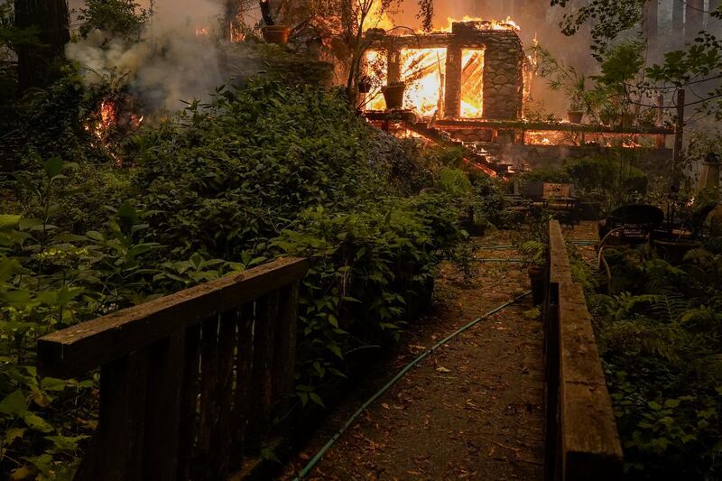 A home burns as the CZU August Lightning Complex Fire passes by in Ben Lomond. AP Photo