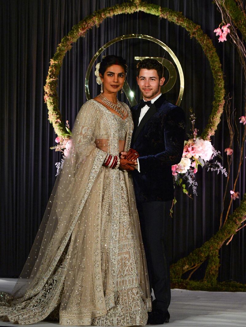 Newlyweds Priyanka Chopra, 36, and Nick Jonas, 26, pose for a photograph during a reception at a hotel in New Delhi on December 4, 2018. Photo: AFP