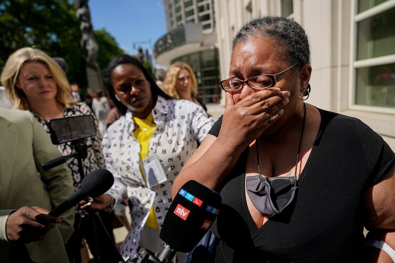 A supporter of R Kelly cries outside the federal court in Brooklyn, New York, on Wednesday after the R&B star was sentenced to 30 years in a federal sex case.  AP