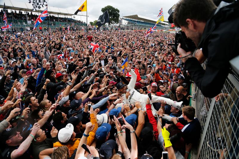 Mercedes drivers Lewis Hamilton of Britain is carried by fans after winning the British Formula One Grand Prix at the Silverstone racetrack in Silverstone, England, Sunday, July 16, 2017. (AP Photo/Frank Augstein)