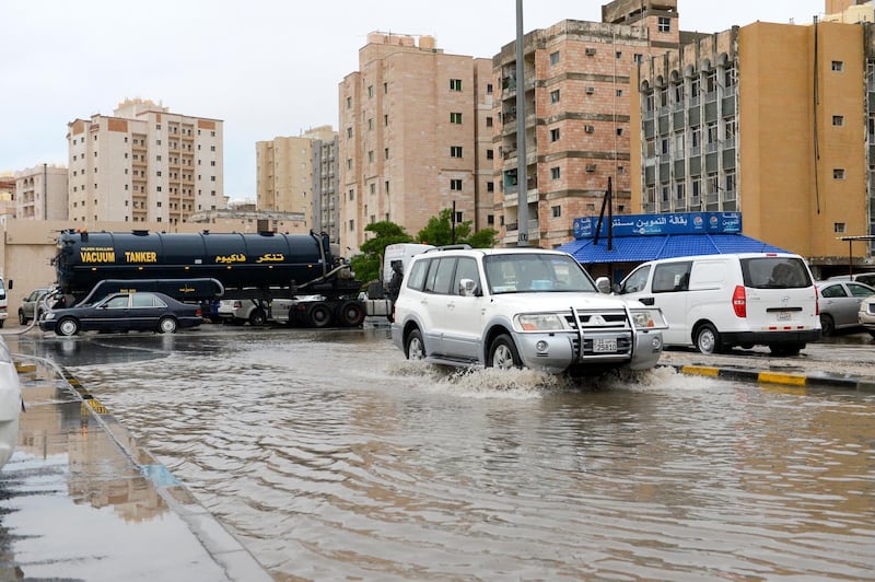 Vehicles drive in a flooded street following heavy rain in Kuwait City. EPA