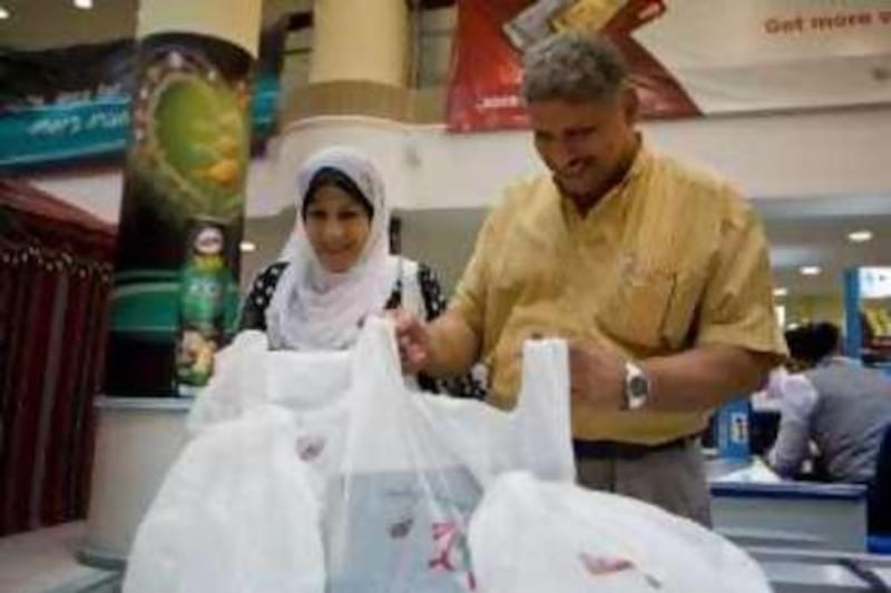 Abu Dhabi - August 28, 2008: Nawal Ahmed (left) and Fattah Ahmed shop for Ramadan at Lulu Hypermarket in Al Wahda Mall. ( Philip Cheung / The National ) For story by Loveday Morris *** Local Caption ***  PC0079-lulu.jpg