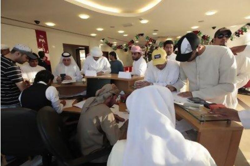 Emiratis register their names for a free flight to Bahrain to watch their national football team. Jeffrey E Biteng / The National