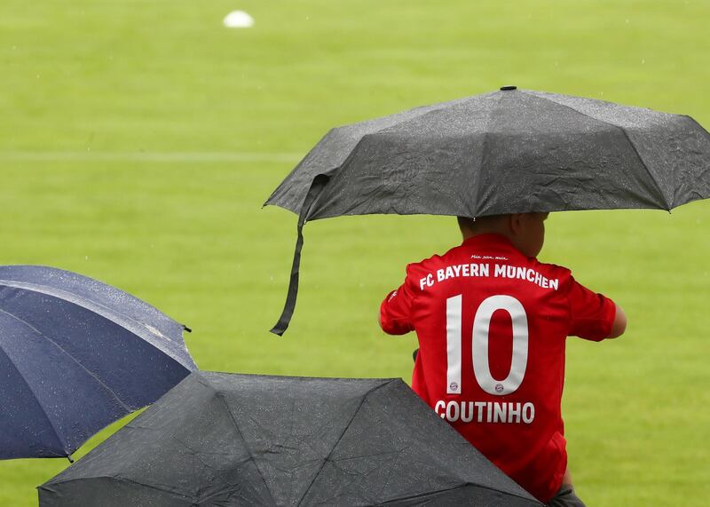 A fan is wearing a Bayern Munich shirt with the name of Coutinho on the back. Reuters