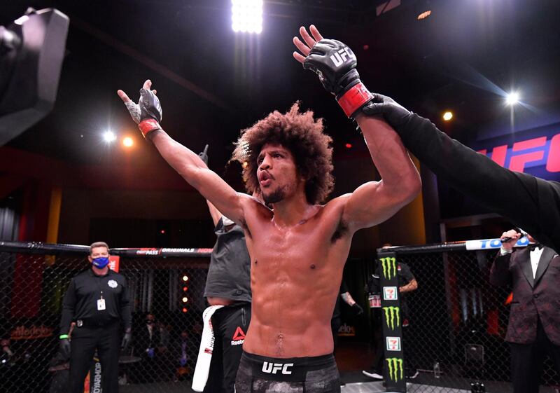 Alex Caceres celebrates after his victory over Chase Hooper in their featherweight bout during UFC 250. Reuters