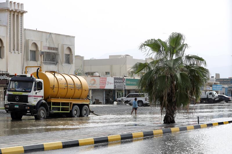 A water tank helps to clear a heavily flooded road in Kalba, Sharjah, on Monday. 

