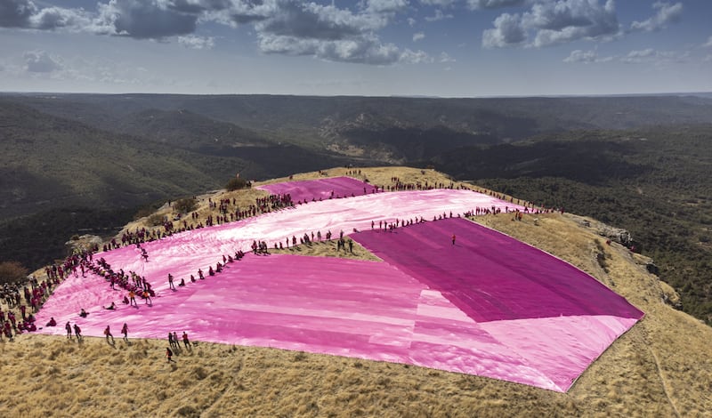 A pink ribbon measuring 25x275 metres placed by more than 540 volunteers on top of the twin mountain named Tetasde Viana, in Trillo town, Guadalajara province, Spain.  This initiative against breast cancer breaks the Guinness Largest Awareness Ribbon record. EPA
