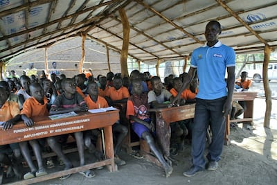 ADJUMANI DISTRICT, Uganda, Tuesday, November 28, 2017 // South Sudanese teacher John Idro, 28, teaches students in a makeshift classroom built by refugee parents at the Liberty Primary School in the Ayilo II refugee settlement in Northern Uganda Tuesday, Nov. 28, 2017. Dubai Cares, in partnership with Plan International, is funding the construction of three new brick classrooms at the school. The three new classrooms will be completed in time for the start of the new academic year, in February. (Roberta Pennington/The National)