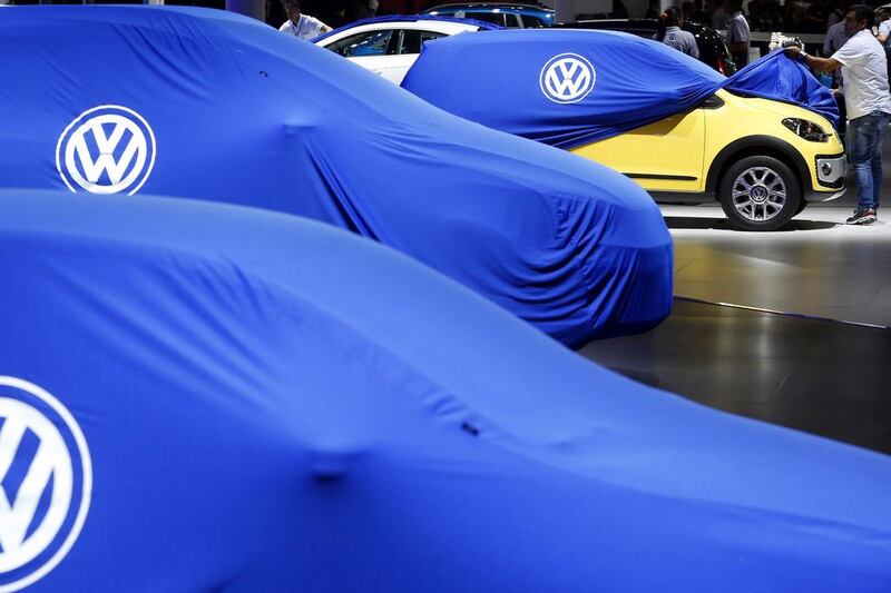 A man unveils a Volkswagen car during the International Sao Paulo Motor Show media day in Sao Paulo on October 28, 2014. Paulo Whitaker / Reuters