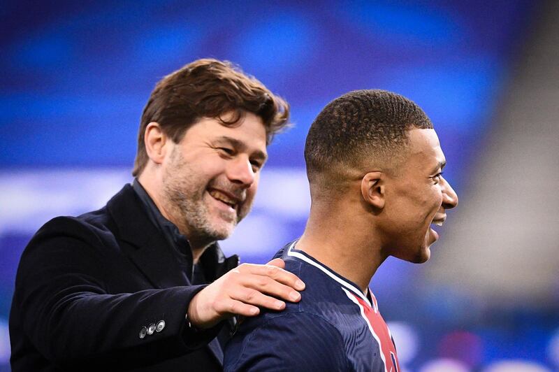 Paris Saint-Germain manager Mauricio Pochettino celebrates with star striker Kylian Mbappe after the French Cup final win over Monaco at Stade de France on Wednesday, May 19, 2021.