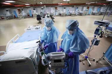 Nurses are seen doing their final check on the equipment in a makeshift ICU "Field Intensive Care Unit 1" set up by Bahrian in Riffa, Bahrain, April 14, 2020. Reuters