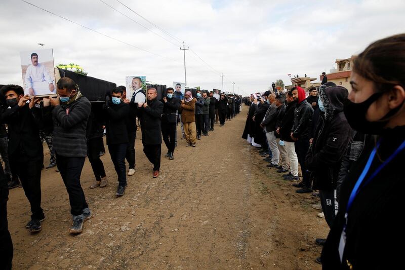 Members of the Yazidi religious minority gather in Kocho, northern Iraq for the burial of 104 members whose remains were identified after being exhumed from ISIS mass graves. Reuters