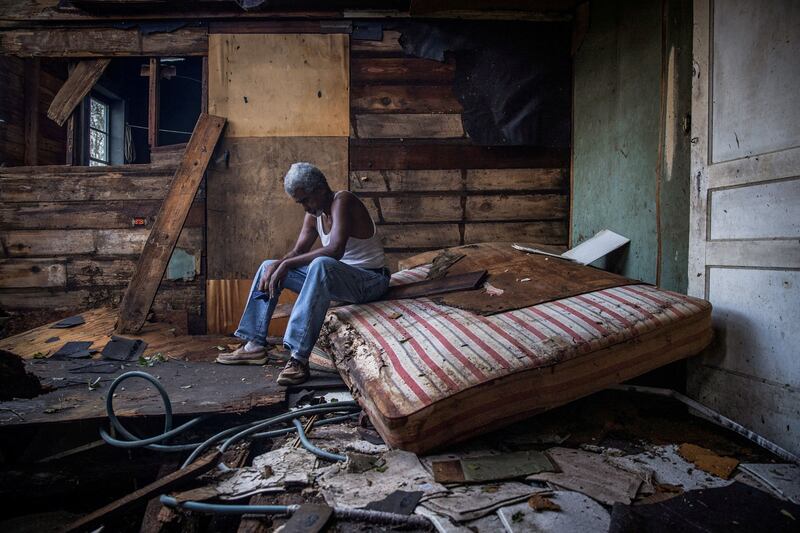 Theophilus Charles, 70, sits inside his house which was heavily damaged by Hurricane Ida in Houma, Louisiana, US, on August 30, 2021. By Adrees Latif, Pulitzer Prize finalist for Feature Photography. Reuters