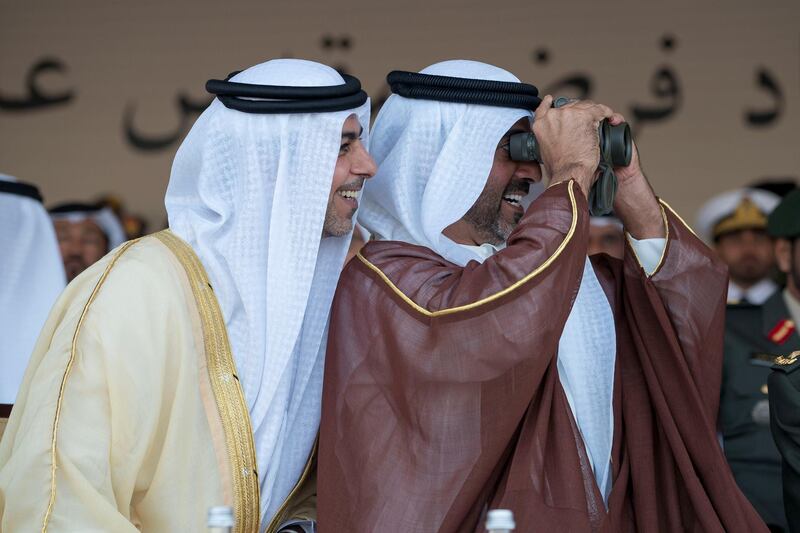 ZAYED MILITARY CITY, ABU DHABI, UNITED ARAB EMIRATES - November 28, 2017: HH Sheikh Omar bin Zayed Al Nahyan, Deputy Chairman of the Board of Trustees of Zayed bin Sultan Al Nahyan Charitable and Humanitarian Foundation (L) and HH Sheikh Hamed bin Zayed Al Nahyan, Chairman of the Crown Prince Court of Abu Dhabi and Abu Dhabi Executive Council Member (R), attend the graduation ceremony of the 8th cohort of National Service recruits and the 6th cohort of National Service volunteers at Zayed Military City. 
( Mohamed Al Hammadi / Crown Prince Court - Abu Dhabi )
---