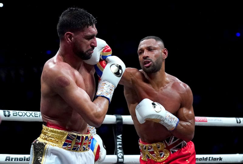 Kell Brook, right, in action against Amir Khan in a welterweight boxing bout at the AO Arena, in Manchester, England, Saturday, Feb.  19, 2022.  (Nick Potts / PA via AP)