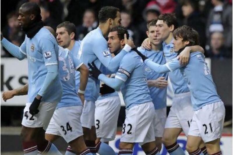 Manchester City players celebrate their first goal at Newcastle United on Sunday, left, which was a triumph for the gameplan of their manager Roberto Mancini.