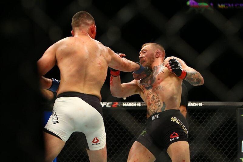 Nate Diaz (L) punches Conor McGregor during UFC 196 at the MGM Grand Garden Arena on March 5, 2016 in Las Vegas, Nevada.   Rey Del Rio/Getty Images/AFP