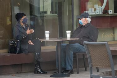 People wearing protective masks sit at a table in the La Jolla neighbourhood of San Diego, California, January 25, 2021. Bloomberg