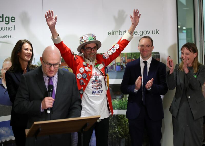 Official Monster Raving Loony Party candidate Baron Badger reacts next to Conservative Party candidate Dominic Raab, Liberal Democrats candidate Monica Harding and independent candidate Kylie Keens during the announcement of voting results for the constituency of Esher and Walton, at a counting centre for Britain's general election in Esher, Britain. Reuters