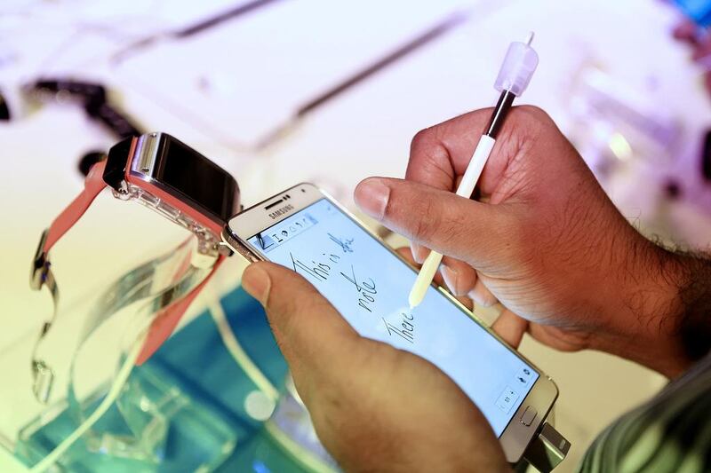 Users test out the new Samsung Galaxy Note 3 and the Galaxy Gear smartwatch at the launch event at Armani Ballroom in Dubai. Sarah Dea / The National.