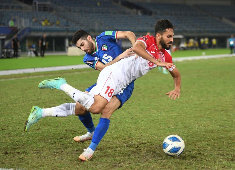 Hamad Qallaf of Kuwait, in blue, challenges Jordan's Mousa Mohammad Suleiman of Jordan, during a Group B qualifier for Qatar 2022, at Jaber Al-Ahmad International Stadium, in Kuwait City, Kuwait. The match ended goalless. EPA