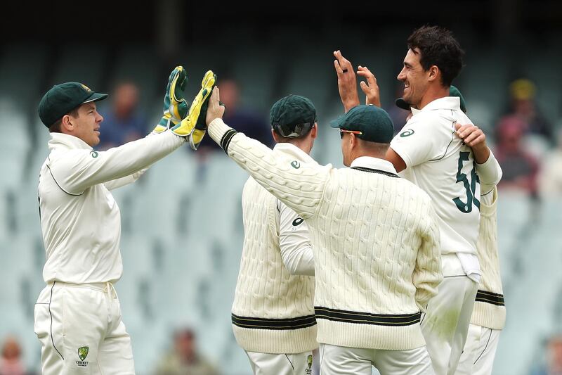 ADELAIDE, AUSTRALIA - DECEMBER 01: Tim Paine and Mitchell Starc of Australia celebrate with their team after combining to take the wicket of Babar Azam of Pakistan during day three of the 2nd Domain Test between Australia and Pakistan at the Adelaide Oval on December 01, 2019 in Adelaide, Australia. (Photo by Mark Kolbe/Getty Images)