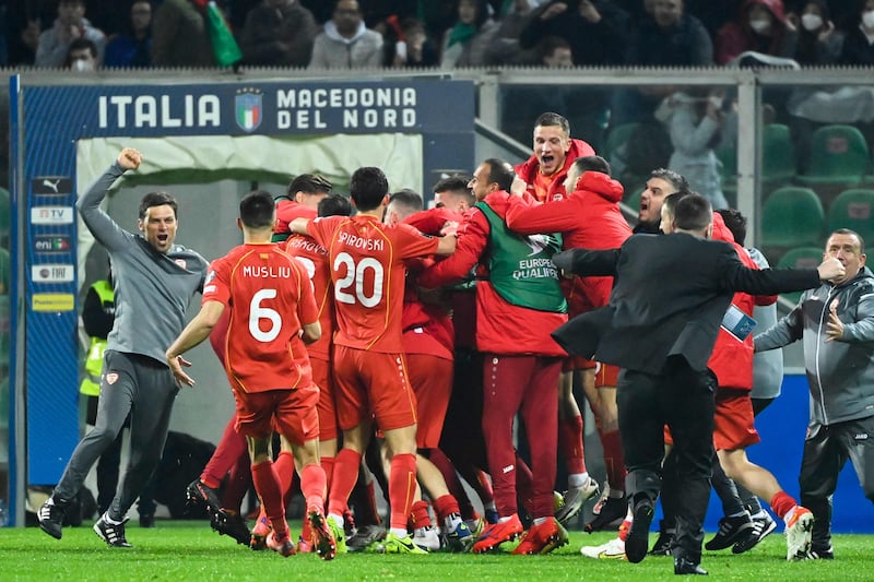 North Macedonia's players celebrate at the end of the 2022 World Cup qualifying play-off victory against Italy at the Renzo-Barbera stadium in Palermo, on Thirsday, March 24, 2022.  AFP