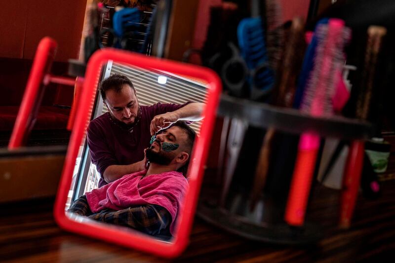 A Kurdish groom gets a haircut ahead of his wedding ceremony in Qamishli in northeastern Syria. AFP