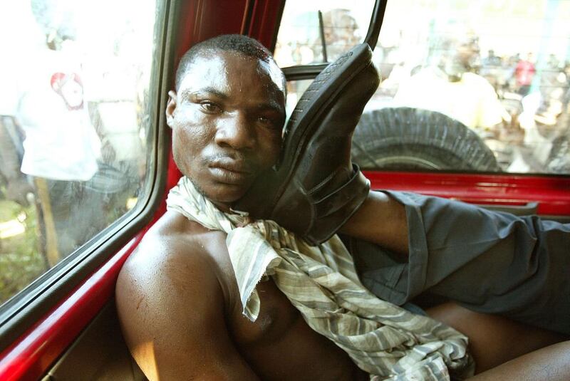 A Haitian suspected of being a multiple assassin for exiled president Jean Bertrand Aristide’s Lavalas party is detained in Petit Goave, on March 3, 2004. Daniel Aguilar / Reuters