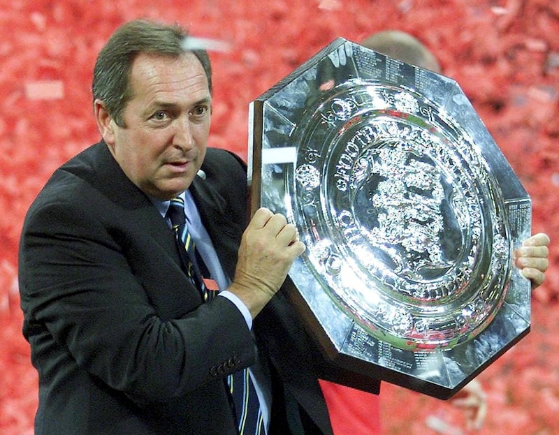 Liverpool manager Gerard Houllier holds aloft the Charity Shield at The Millenium Stadium in Cardiff, 12 August 2001. EPA