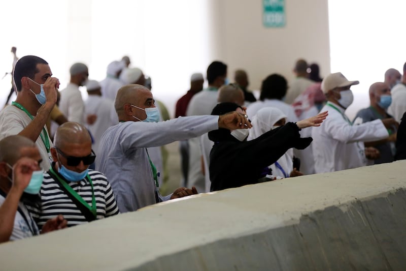 Pilgrims cast stones in a ritual stoning of Satan during Hajj.