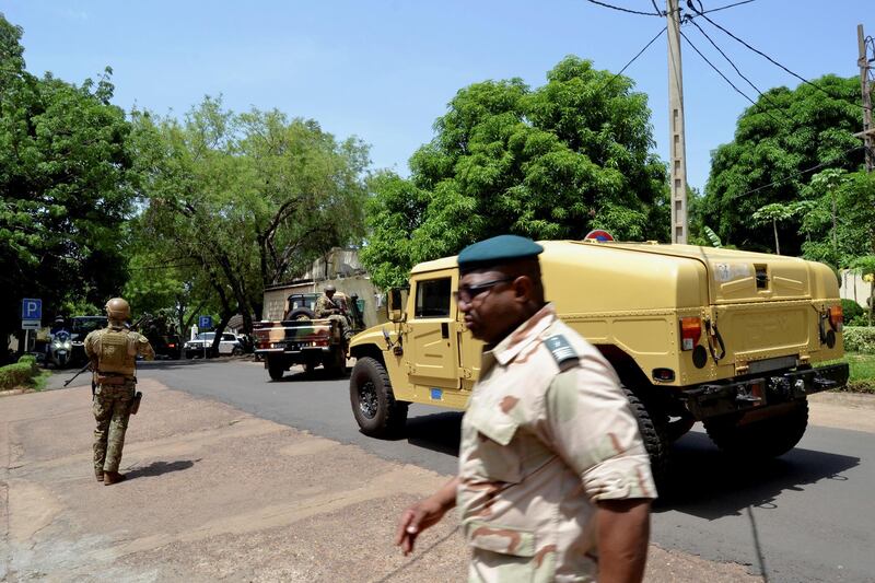 Army members stand guard as the Economic Community of West African States (ECOWAS) mediators delegation meet with Vice President Colonel Assimi Goita about the Mali crisis, in Bamako, Mali, May 26, 2021. REUTERS/Amadou Keita