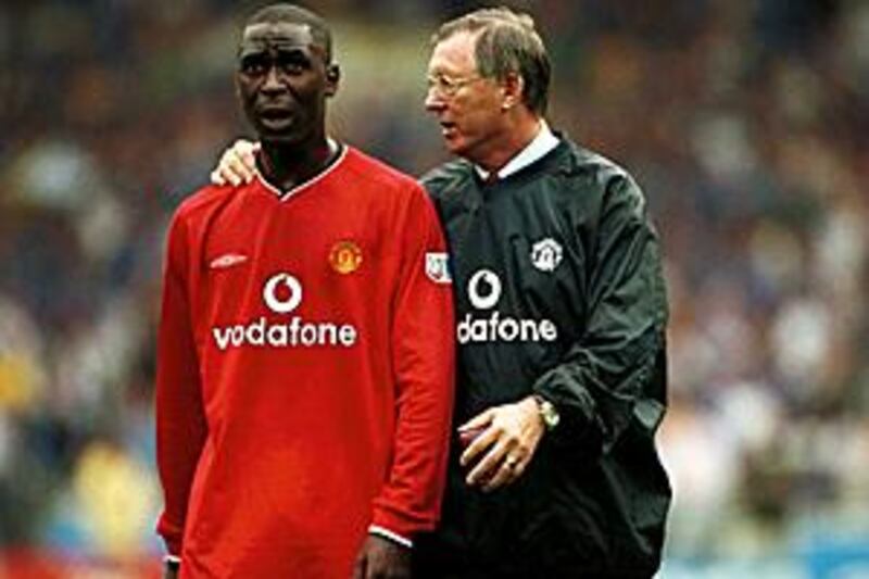 Sir Alex Ferguson, pictured on the field with Andrew Cole.