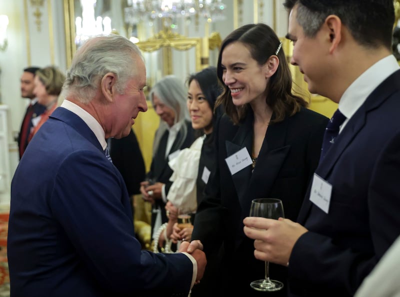 King Charles meets TV presenter and fashion designer Alexa Chung, and Dominic Chung, at the reception. AP