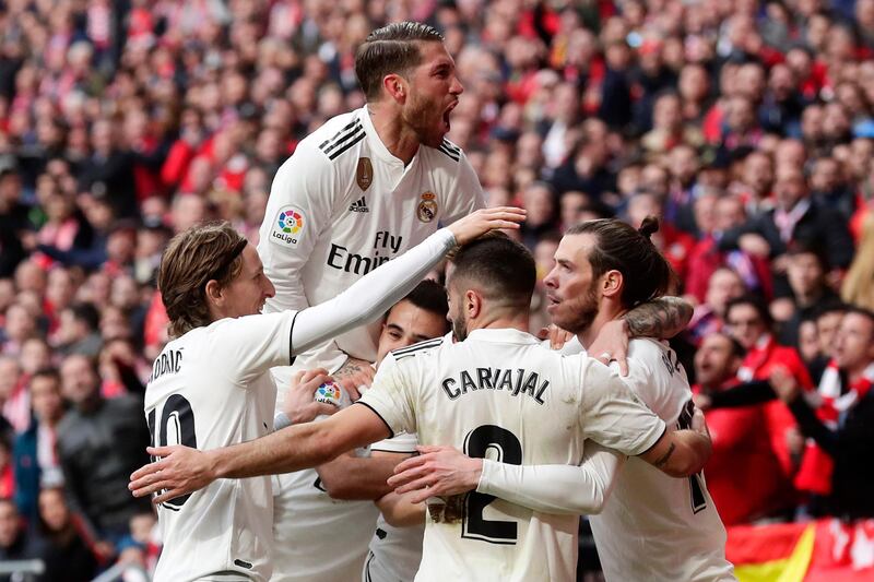 Real Madrid's Gareth Bale, right, celebrates with team mates after scoring his side's 3rd goal during a Spanish La Liga soccer match between Atletico Madrid and Real Madrid at the Metropolitano stadium in Madrid, Spain, Saturday, Feb. 9, 2019. (AP Photo/Manu Fernandez)